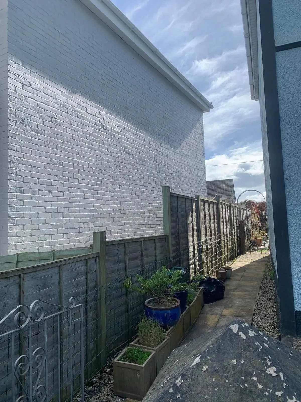 Freshly painted brick wall after preparation and masonry paint in Teignmouth